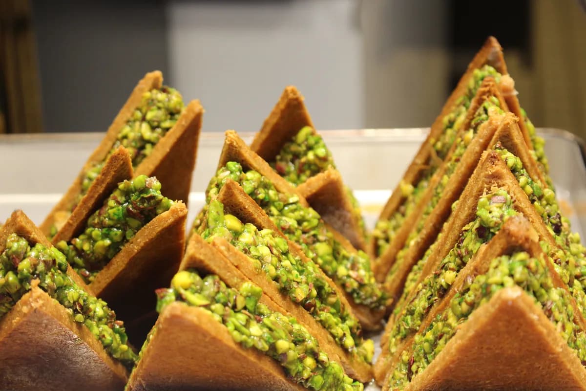 Stacked pistachio baklava triangles cut and ready to serve