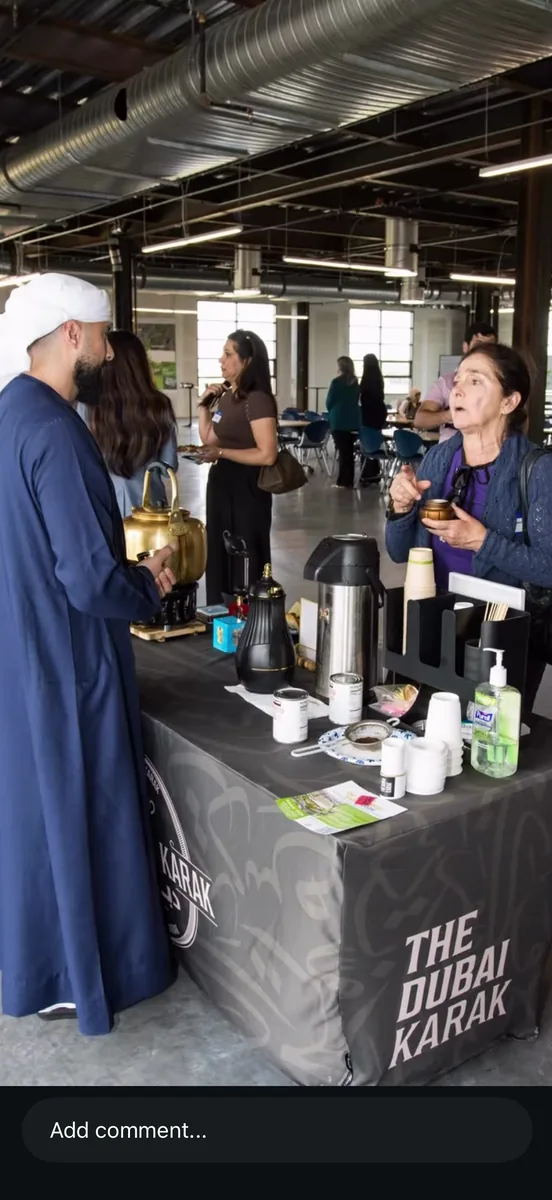 Guests served hot tea and coffee from The Dubai Karak counter at an indoor corporate event